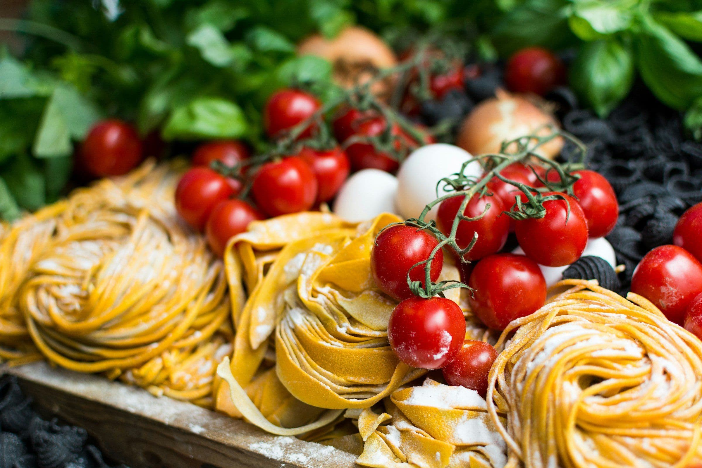 Fresh pasta and tomatoes at an Italian food market