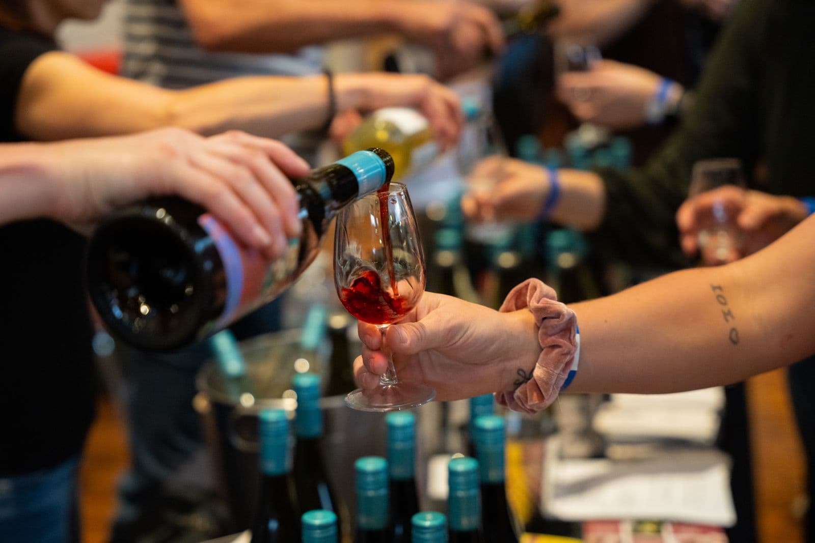 Wine being poured into glass during interactive tasting workshop with participants