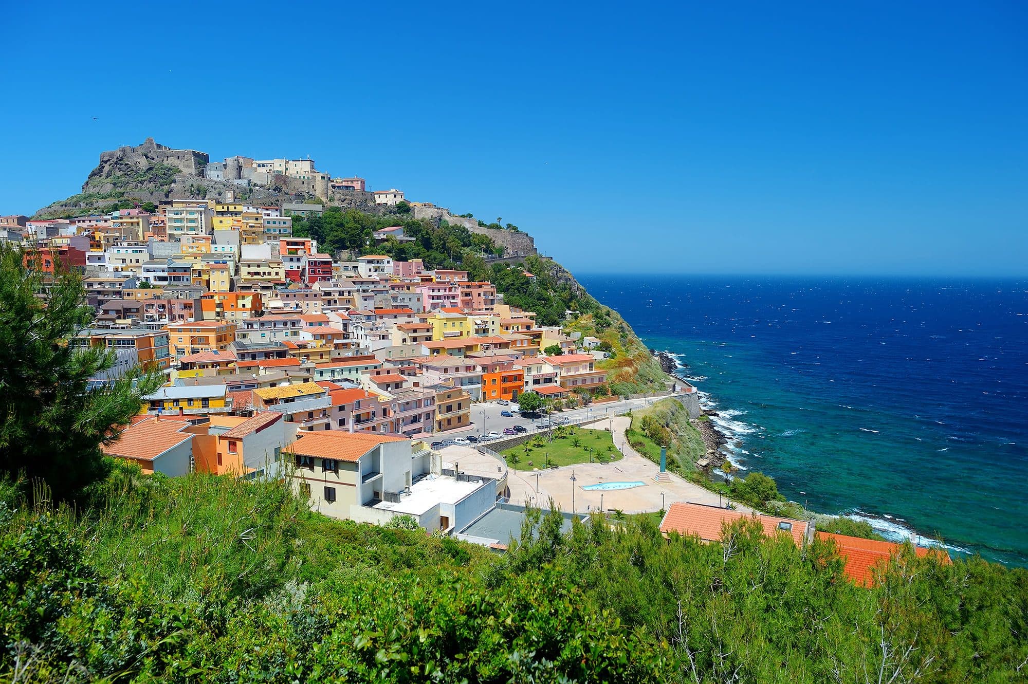 Colorful Italian coastal village hillside overlooking turquoise Mediterranean sea