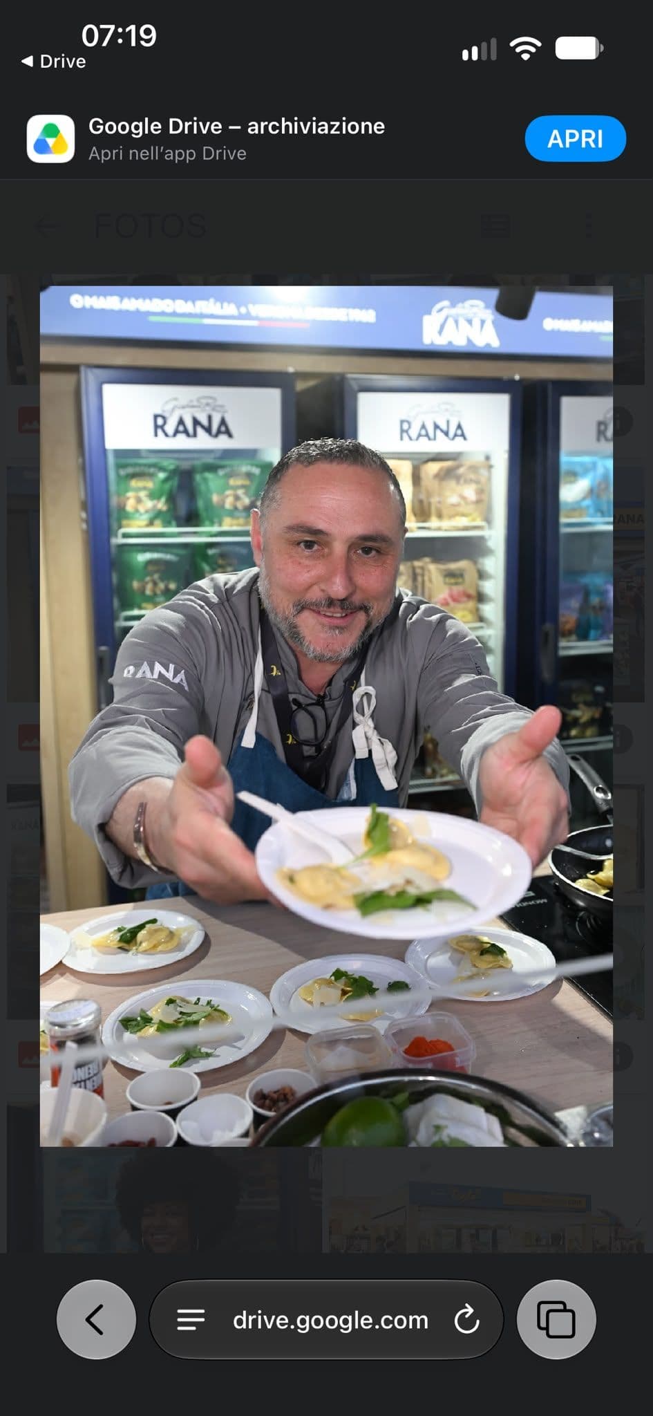Flavio Gallotta smiling as he offers a freshly plated meal
