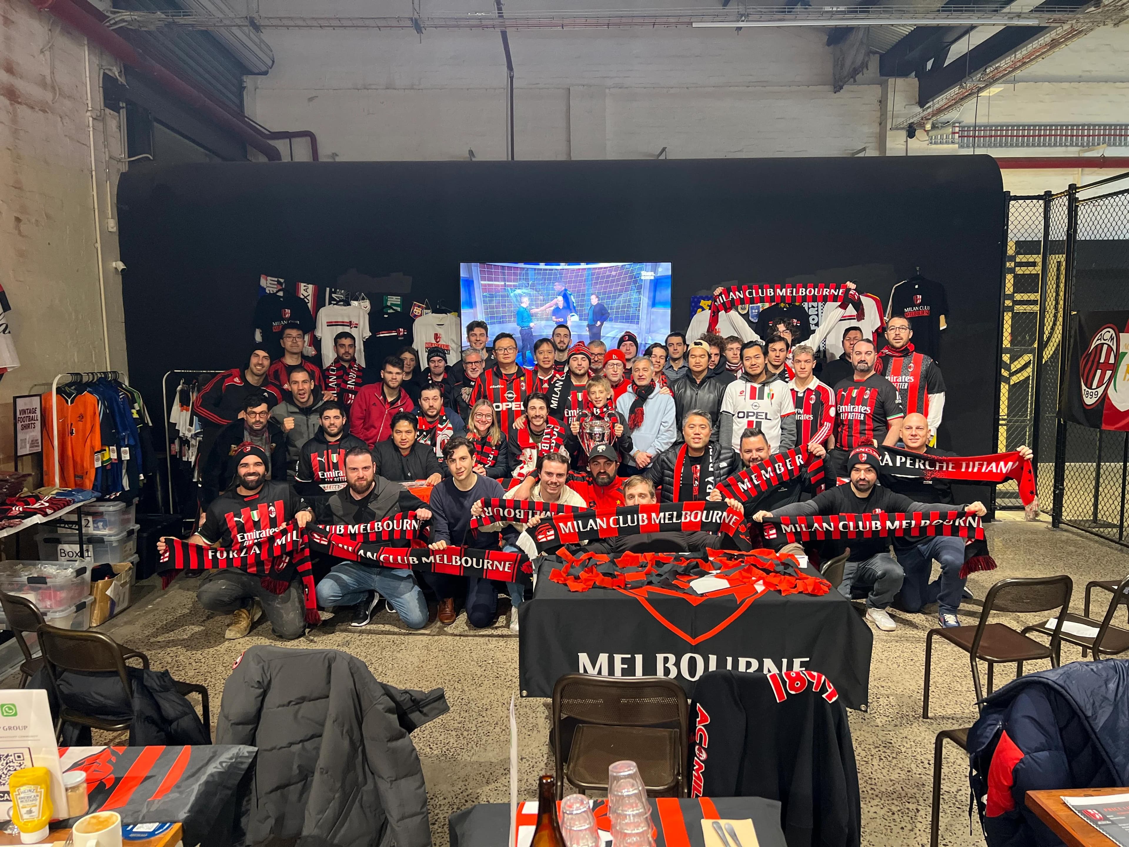 Milan Club Melbourne members posing together with scarves and merchandise