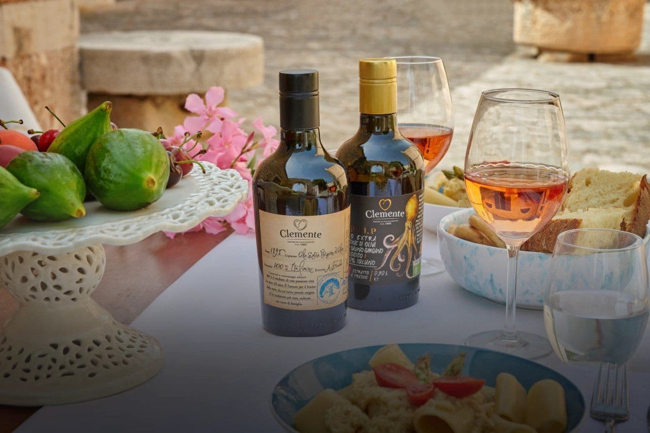 Bottles of Olio Clemente extra virgin olive oil on a table