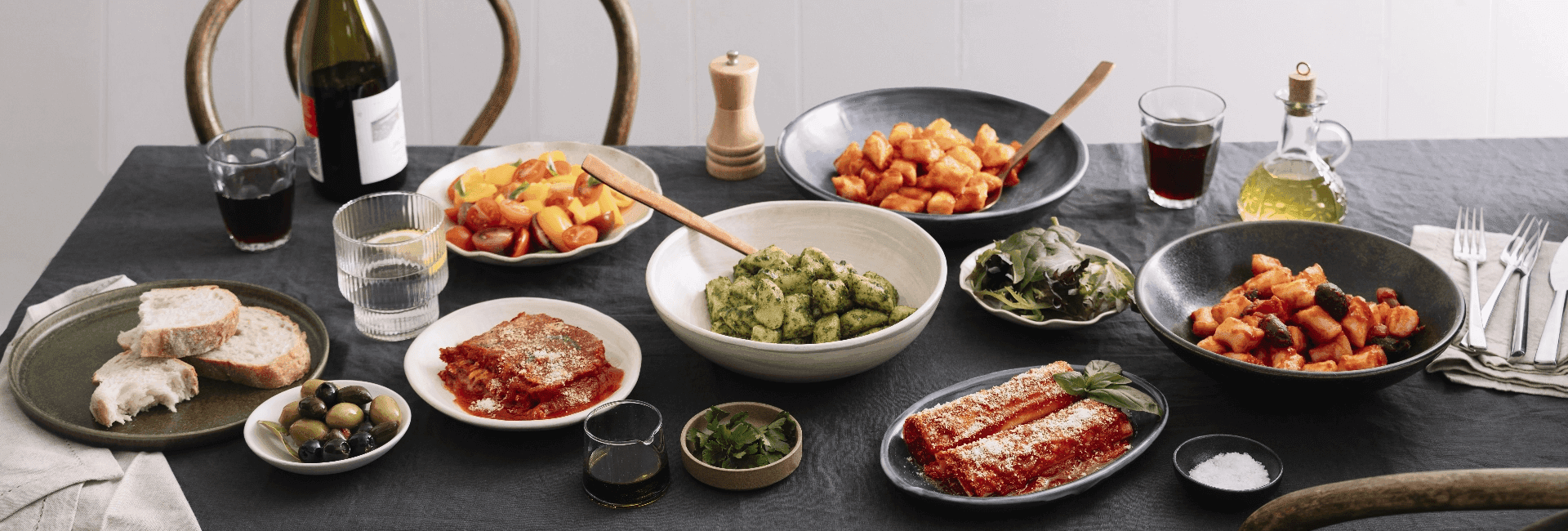 Italian dishes spread with pasta, lasagne, olives, wine, bread