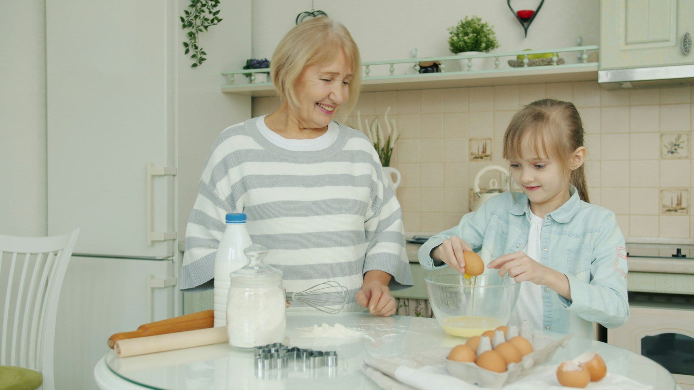 Grandmother and granddaughter baking together in a kitchen