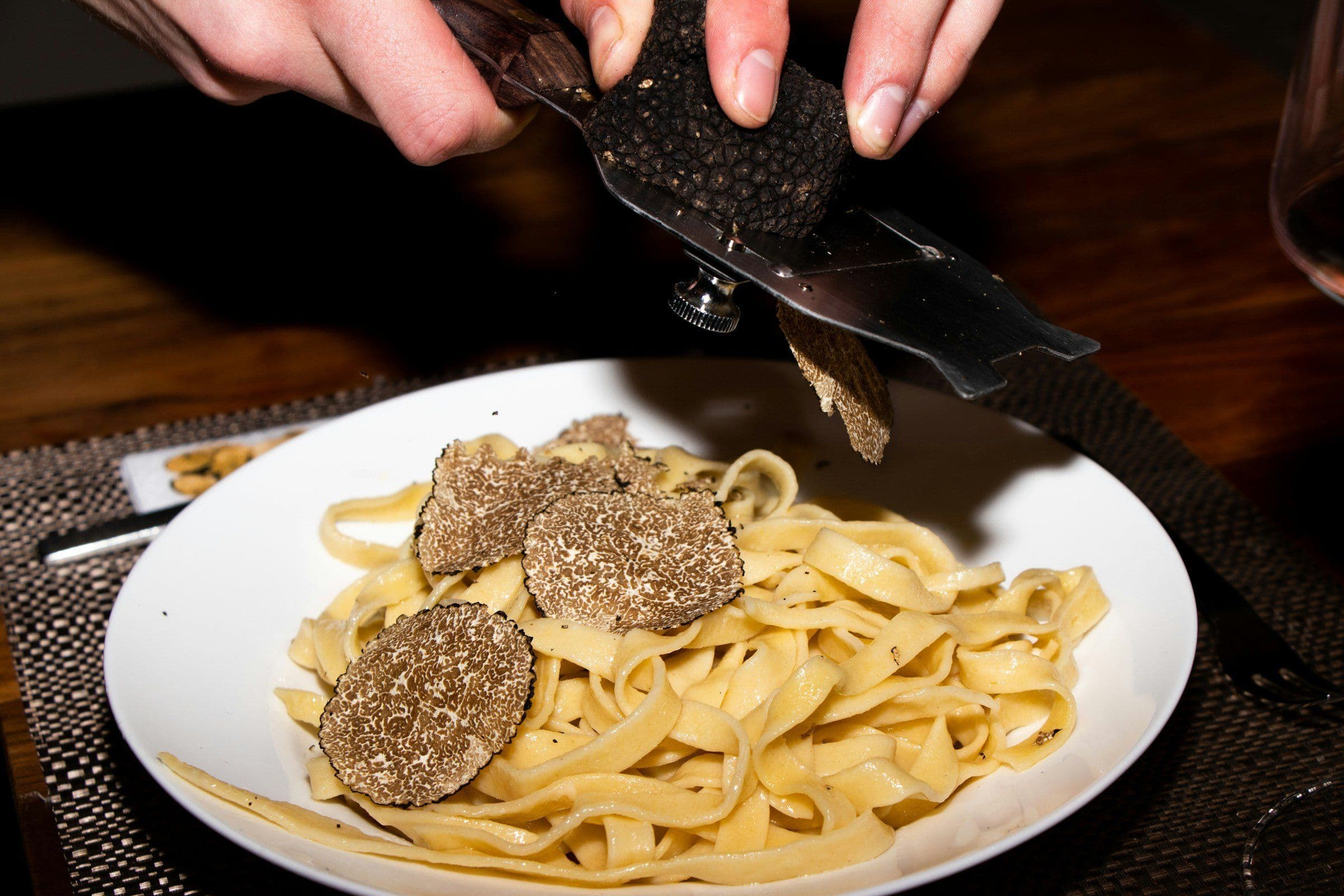 Truffle being shaved over tagliolini
