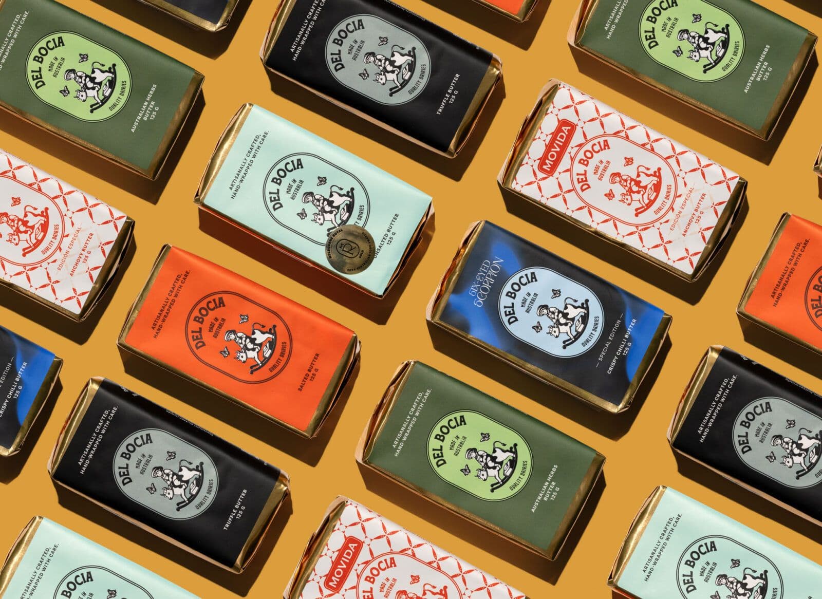 Colorful foil-wrapped Del Bocia butter bars arranged diagonally