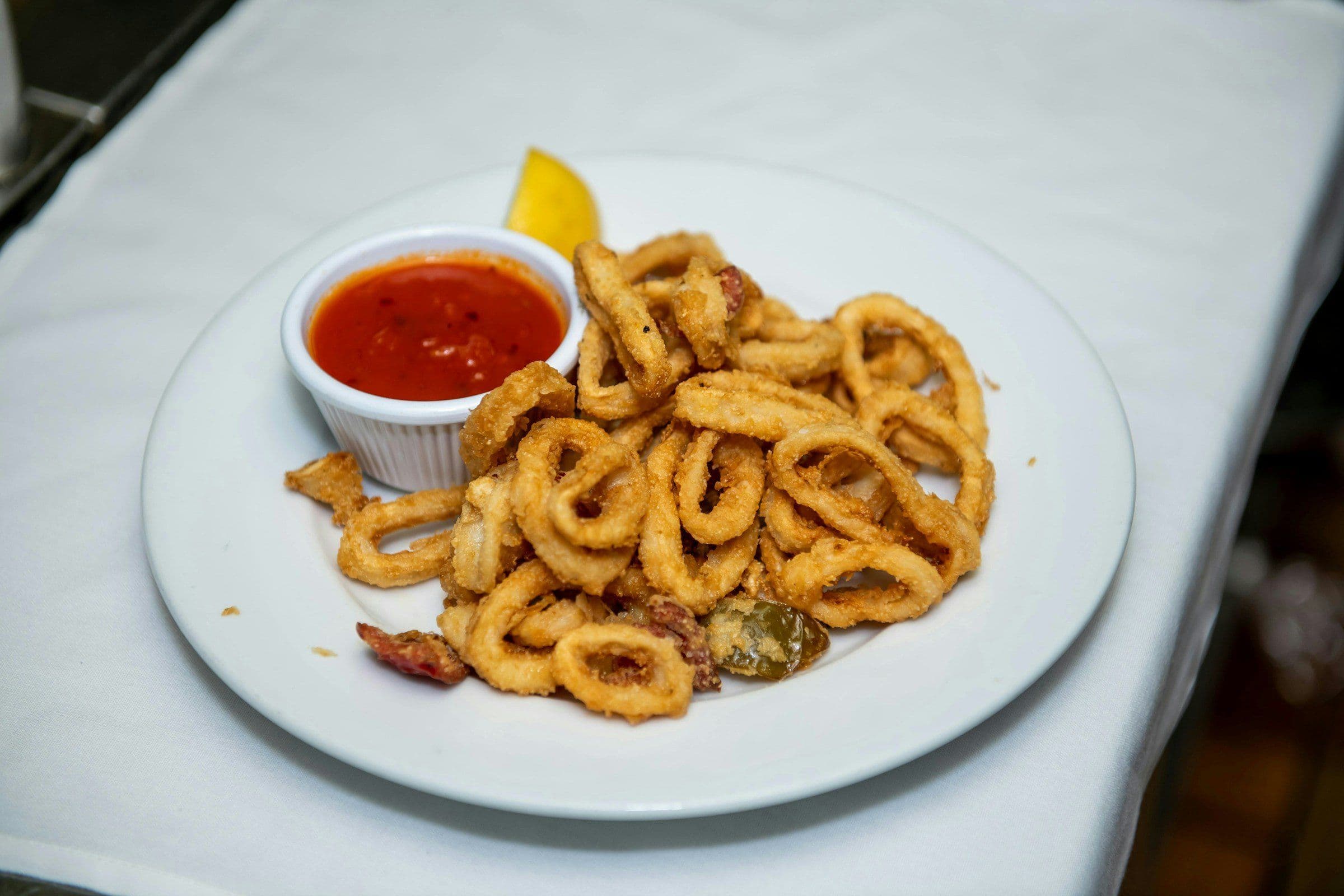 Plate of crispy fried calamari with lemon
