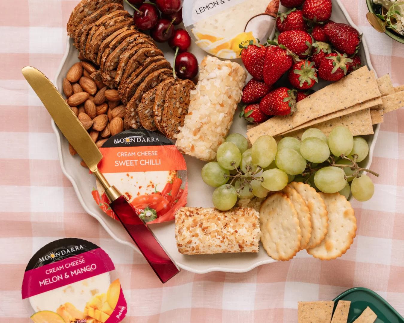 Cheese platter with fruit, crackers, almonds and cheese products