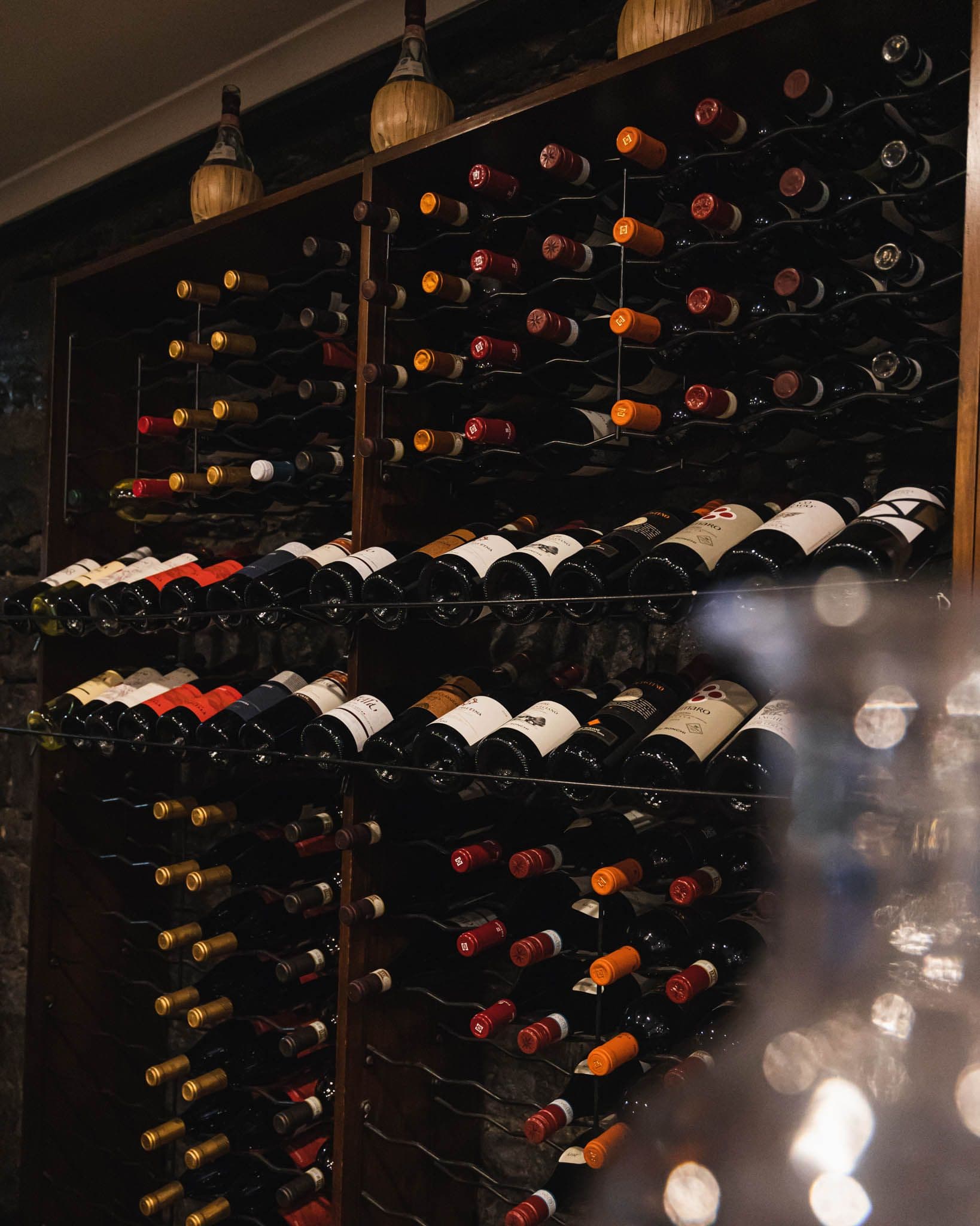 Wine cellar shelves stocked with numerous wine bottles
