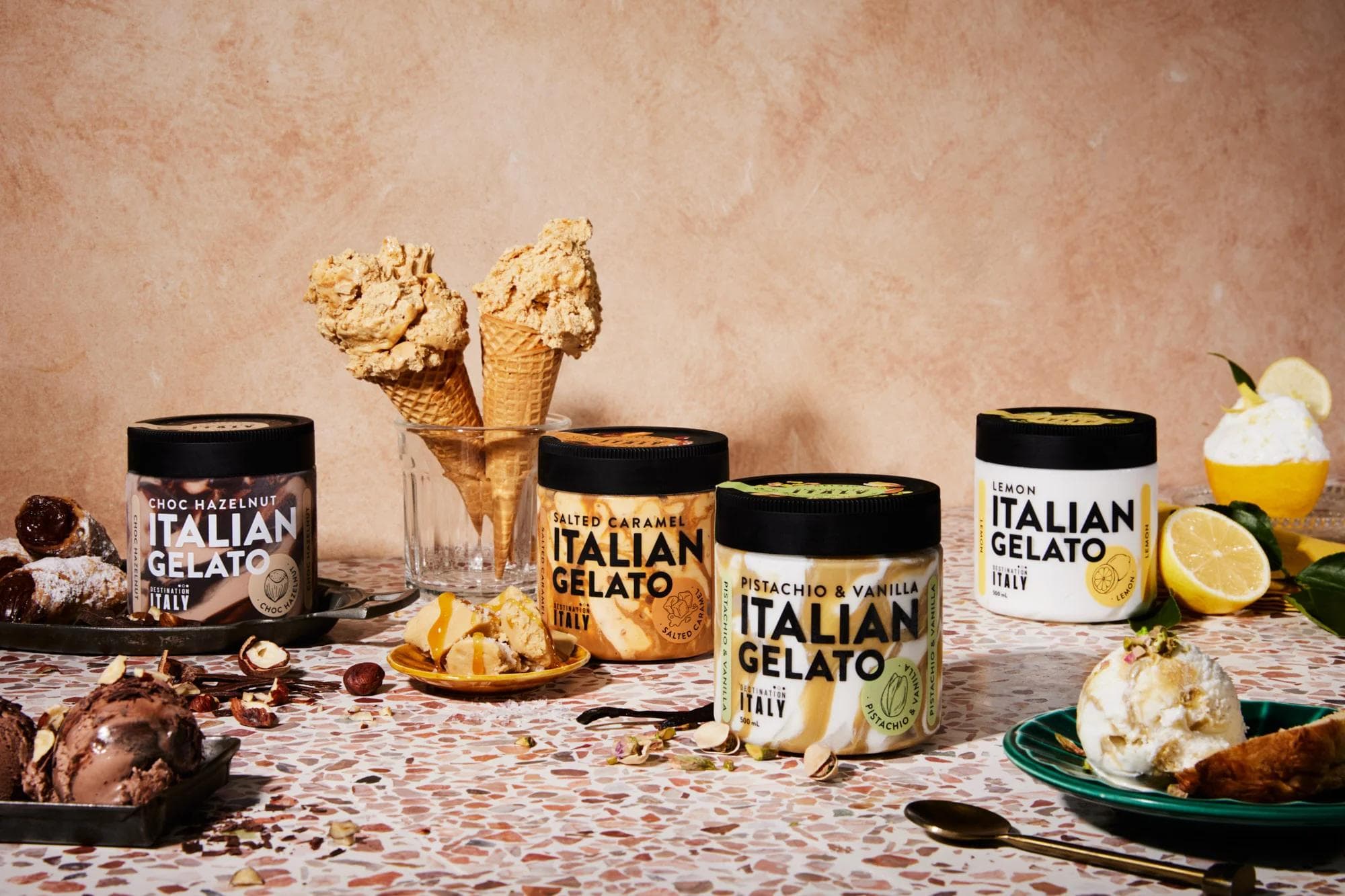 Italian Gelato tubs and cones displayed with fruit garnish